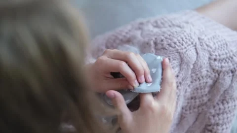 Close-up of a child's hands sewing a soft toy. Stock Footage 243259860