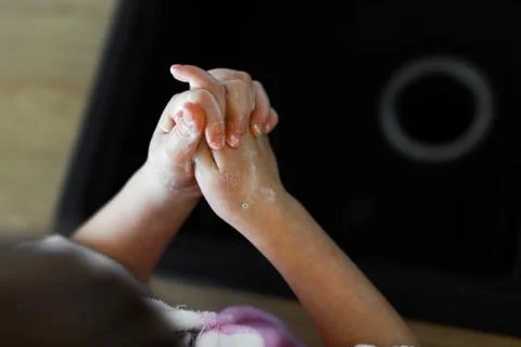 Close up child's hands in soap bubbles with irritation Stock Photos