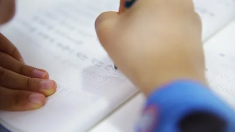 Close-up of a Child’s Hands Transcribing Bible Verses in Korean in a Notebook Video stock 331074053