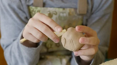 Close-up of a child's hands working with clay, demonstrating creativity Stock Footage 303760260