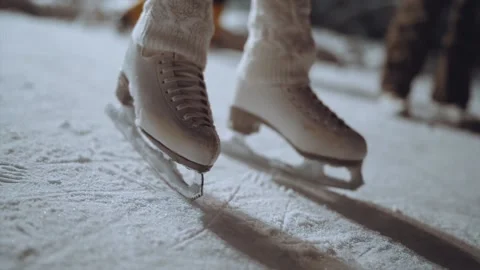 Close-up of a child's skates in the process of skating on the rink Stock Footage 167340512