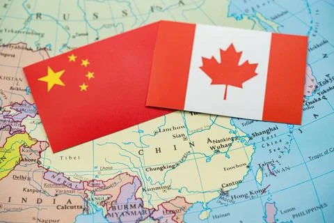 Close up of China and Canada flags on map of Asia 写真素材