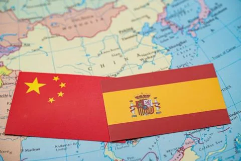 Close up of China and Spain flags on map of Asia Stock Photos