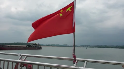 Close-Up of Chinese Flag Flapping in Wind on Yacht Railing by Calm Water Stock Footage 329947363
