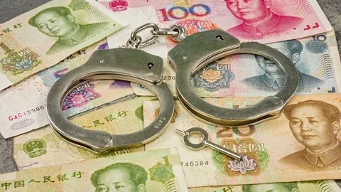 Close up of chinese yen bank notes and handcuffs. Chinese corruption. 스톡 동영상 79814428