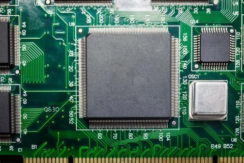 Close-up of a chip on a computer board and a small smart device processing Stock Photos