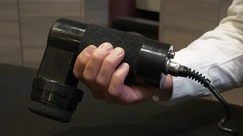 Close up of chiropractor with massage gun on table. Video stock 259756623