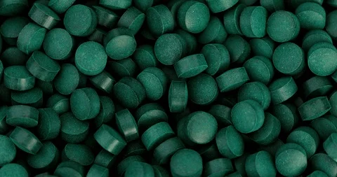 Close up chlorophyll spirulina tablet rotation , healthy detox suplement , 4k Stock Footage 106800731