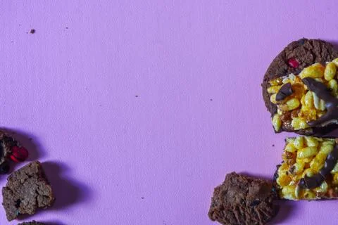 Close-up of choco chips and choco nuts on a purple background. Stock Photos