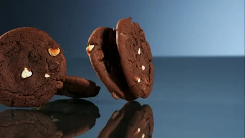 Close up of chocolate chip cookie breaking in half with crumbs Stock Footage 326029955