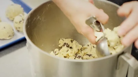 Close-Up of Chocolate Chip Cookie Dough Being Scooped into Balls Stock Footage 280136163