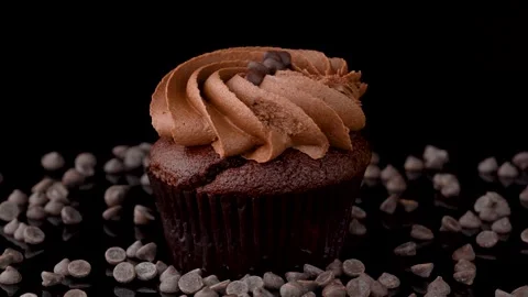 Close Up Chocolate Cupcake on Reflective Surface 스톡 동영상 330517510