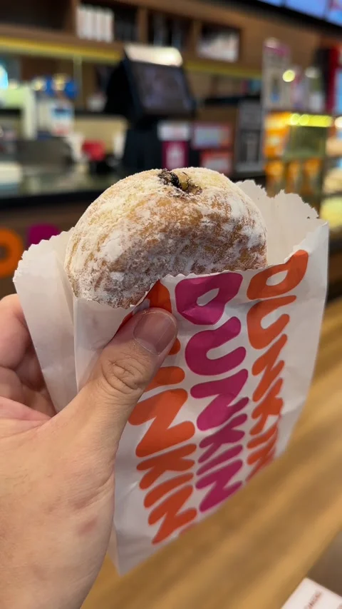 Close Up of A Chocolate Filled Donut of Dunkin' Donuts Stock Footage 228577996