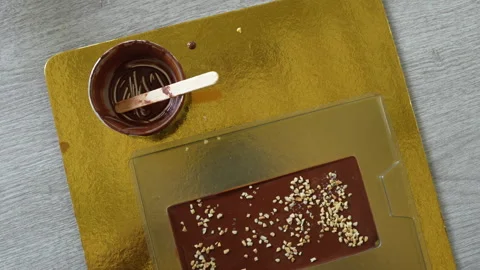 Close-up of Chocolate Preparation with Nut Sprinkles Stock Footage 321792753