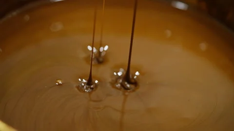 Close-up of chocolate sauce swirling, creating a mesmerizing pattern. 스톡 동영상 276406852