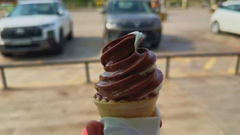 Close Up of Chocolate Soft Serve Ice Cream Cone Gently Spinning to Reveal Stock Footage 340300703