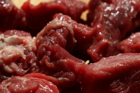 Close up of choped red beef or goulash on a wooden cutting board Stock Photos