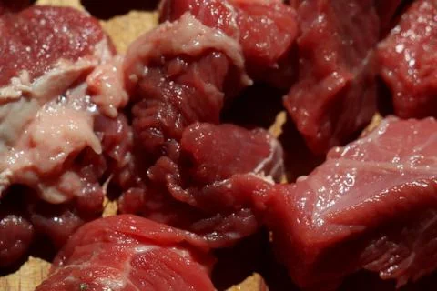 Close up of choped red beef or goulash on a wooden cutting board Foto stock