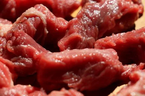 Close up of choped red beef or goulash on a wooden cutting board Stock Photos