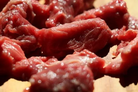 Close up of choped red beef or goulash on a wooden cutting board Stock Photos
