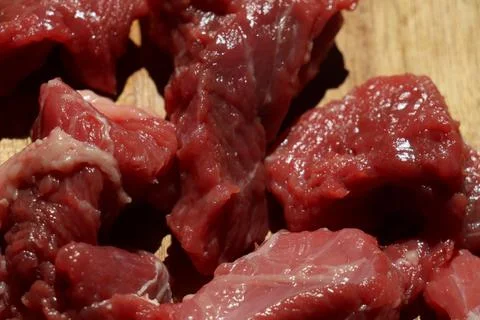 Close up of choped red beef or goulash on a wooden cutting board Stock Photos