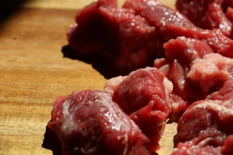 Close up of choped red beef or goulash on a wooden cutting board Stock Photos