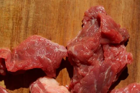 Close up of choped red beef or goulash on a wooden cutting board Stock Photos