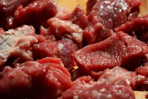 Close up of choped red beef or goulash on a wooden cutting board Stock Photos
