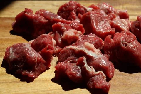 Close up of choped red beef or goulash on a wooden cutting board Stock Photos