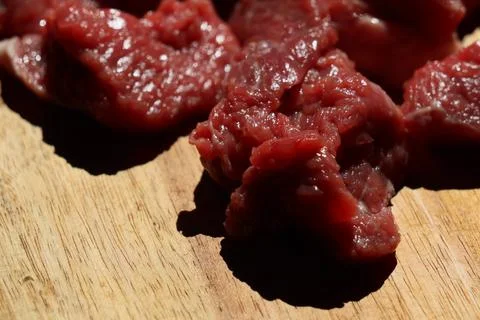 Close up of choped red beef or goulash on a wooden cutting board Stock Photos