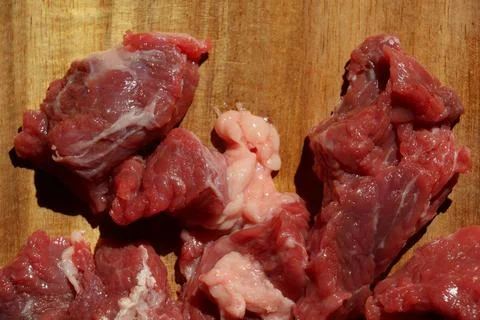 Close up of choped red beef or goulash on a wooden cutting board Stock Photos