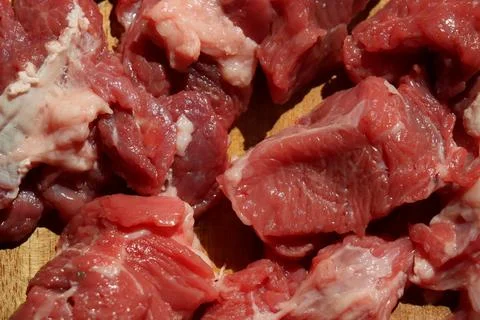 Close up of choped red beef or goulash on a wooden cutting board Stock Photos