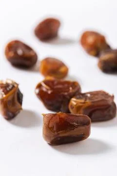 Close-Up of Chopped Fresh Dates on White Background Stock Photos