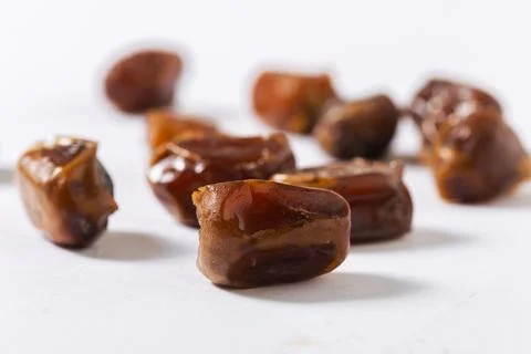 Close-Up of Chopped Fresh Dates on White Background Stock Photos