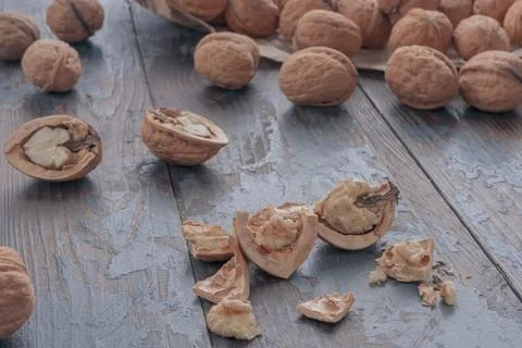 Close-up of a chopped walnut, on a blurry background a scattering of whole .. 스톡 사진
