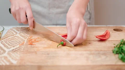 Close-up chopping Chili Pepper with a chef knife in 4K. Stock Footage 138303218