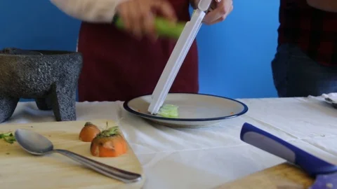 Close up of chopping cucumber with mandolin slicer, handheld shot Stock-Footage 124664280
