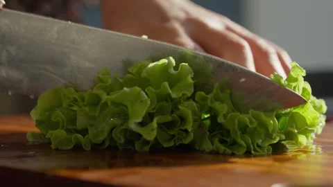 Close Up of Chopping Fresh grreen Leaf Lettuce on Wooden Board Stock Footage 336466815