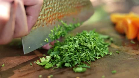Close Up of Chopping Fresh Herbs On A Cutting Board Video stock 280099688