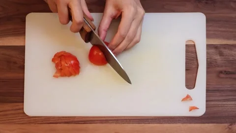 Close Up of Chopping Fresh Tomatoes on Cutting Board in Kitchen-Horizontal Stock Footage 333784294