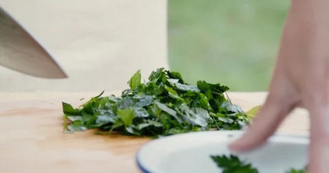 Close-up of chopping parsley and mint Stock Footage 119845936