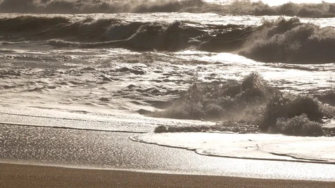 Close up choppy waves breaking on sandy beach with reflections on water surface Stock Footage 103291177