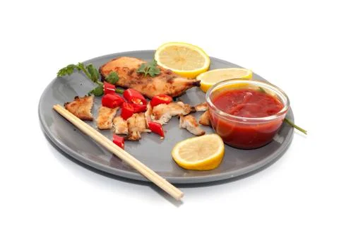 Close up of chopstick and chicken breast with sauce Stock Photos