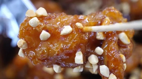 Close-up of Chopstick Picking Up Crispy Korean Fried Chicken (Dakgangjeong) Glaz Video stock 343027034