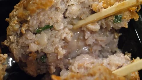 Close-Up of Chopsticks Breaking Open a Giant Chinese Lion's Head Meatball (Shizi Video stock 343587300