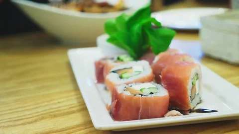 Close-up. chopsticks taking a sushi roll from a plate in a restaurant Stock Footage 100664865