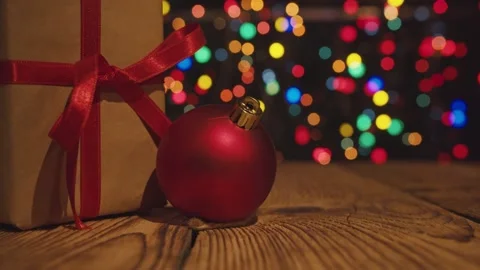 Close-up of the christmas gift boxe with red ribbon on table with bokeh lights. Stock Footage 144325774