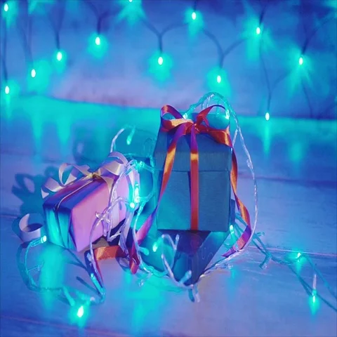 Close up of christmas gift boxes with blue garland Stock Footage 69705363