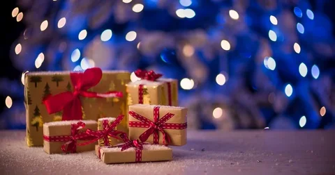 Close up of christmas gift boxes with blue flashing garland 库存影片 83025113