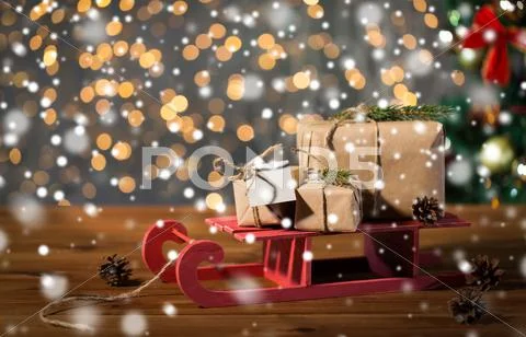 Close up of christmas gift boxes on wooden sleigh Stock Photos